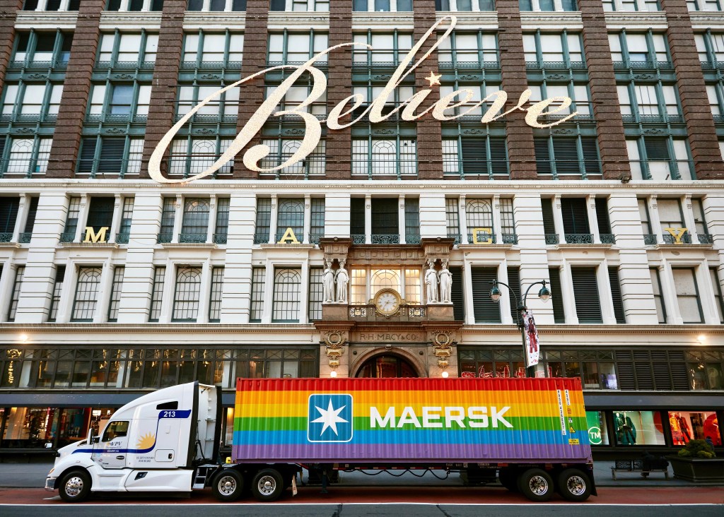 Maersk Rainbow container in front of Macy's Retail Store in New York City. Building says Believe. 